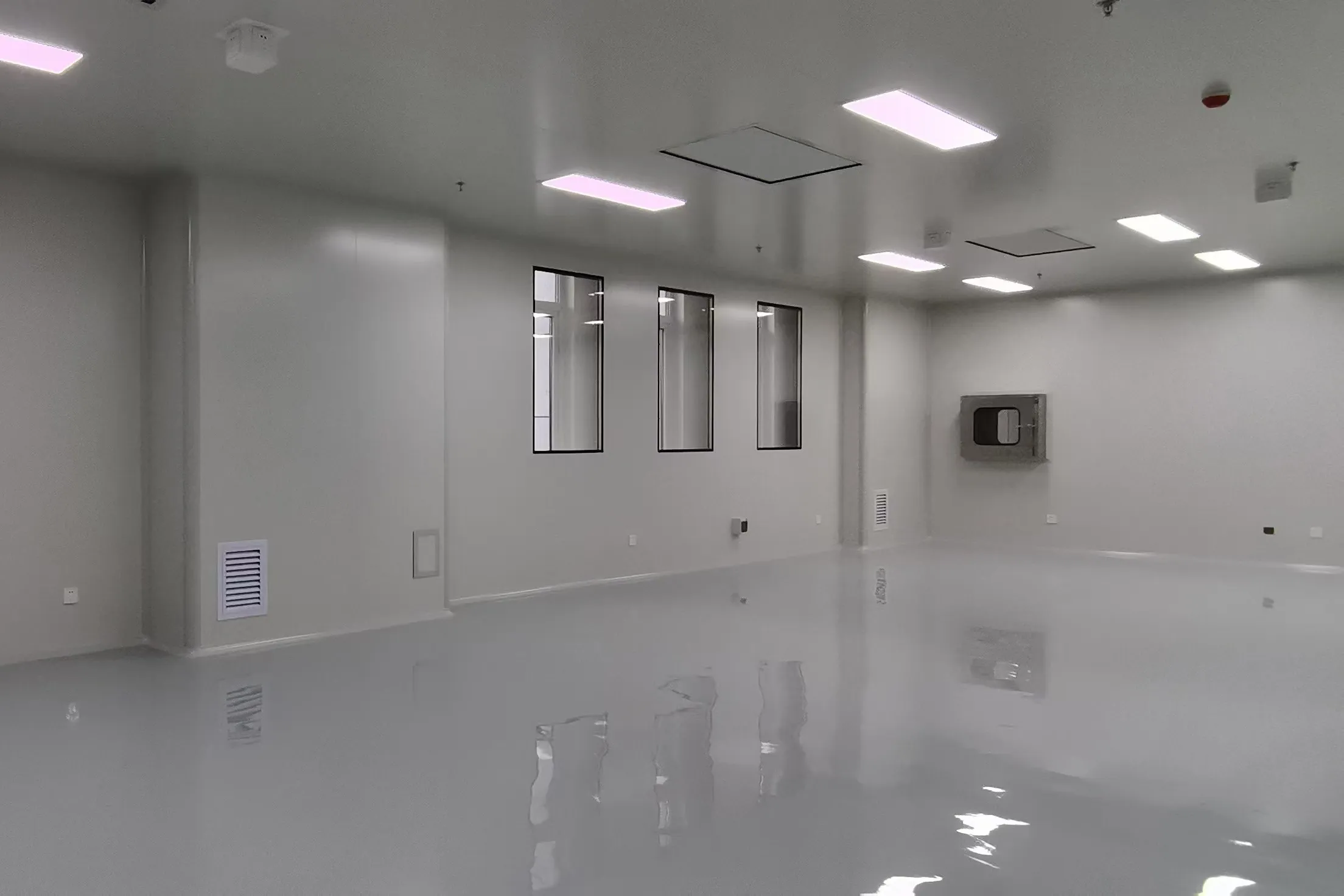 Production room with pass box and low wall return air grilles